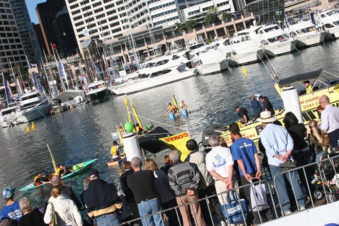 The crowds were 10-deep, watching and cheering on the teams of 2 who built and manned their boats for a hectic race around Cockle Bay. © Jeni Bone